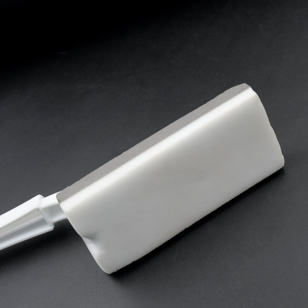 Triangle cleaning brush efficiently cleaning bathroom tiles and grout lines.