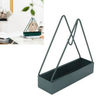Black wrought iron mosquito coil holder showcasing its unique triangular design.