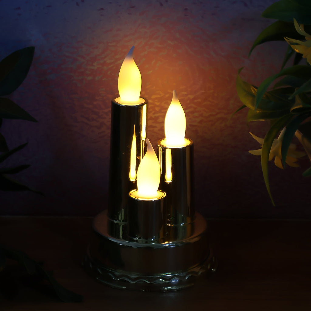 Golden candle lamp with triple LED candles illuminating festive space