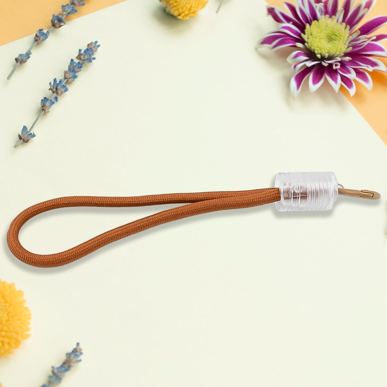 Versatile wrist strap lanyard holding a phone, keys, and a USB drive, showcasing its multipurpose use.