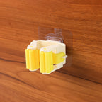 Close-up of the self-adhesive mop holder's strong spring clip gripping a broom handle.
