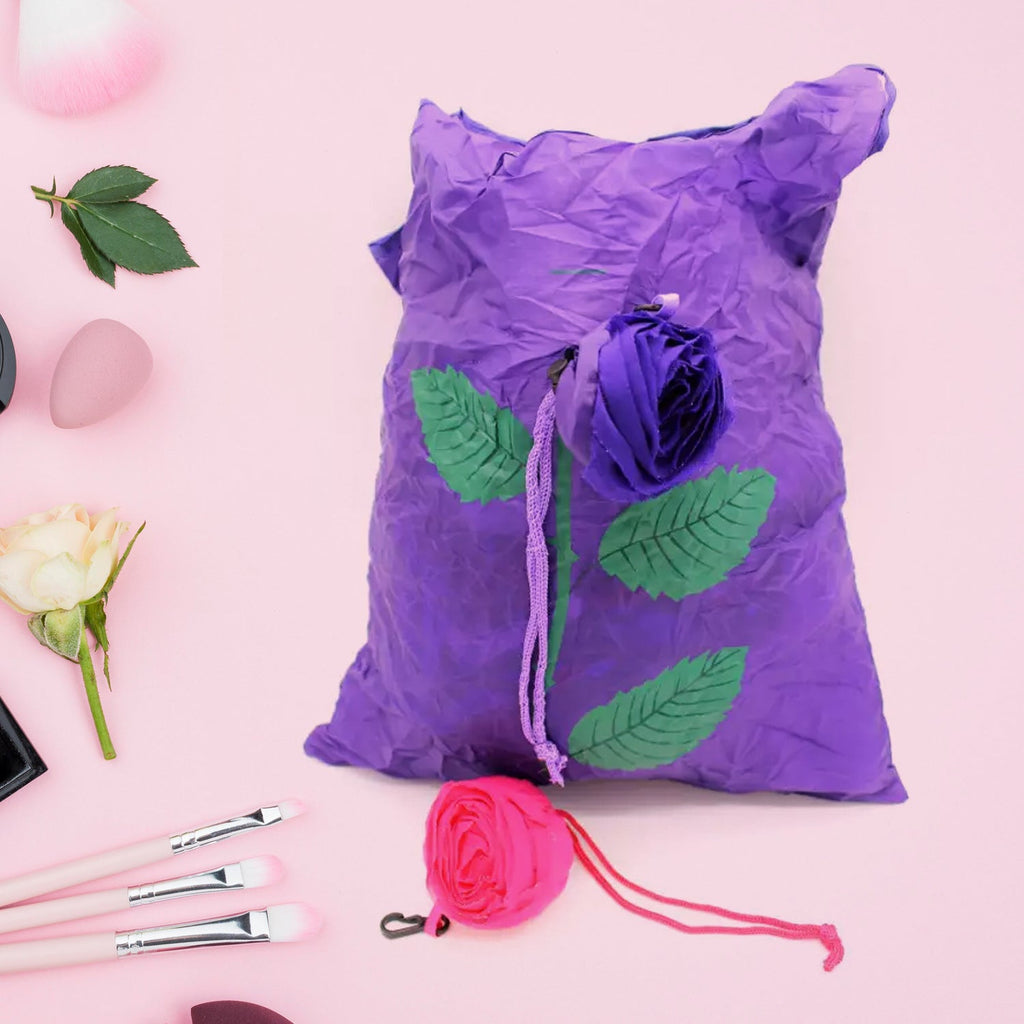 Unfolded reusable shopping bag featuring a vibrant rose design against a plain background.