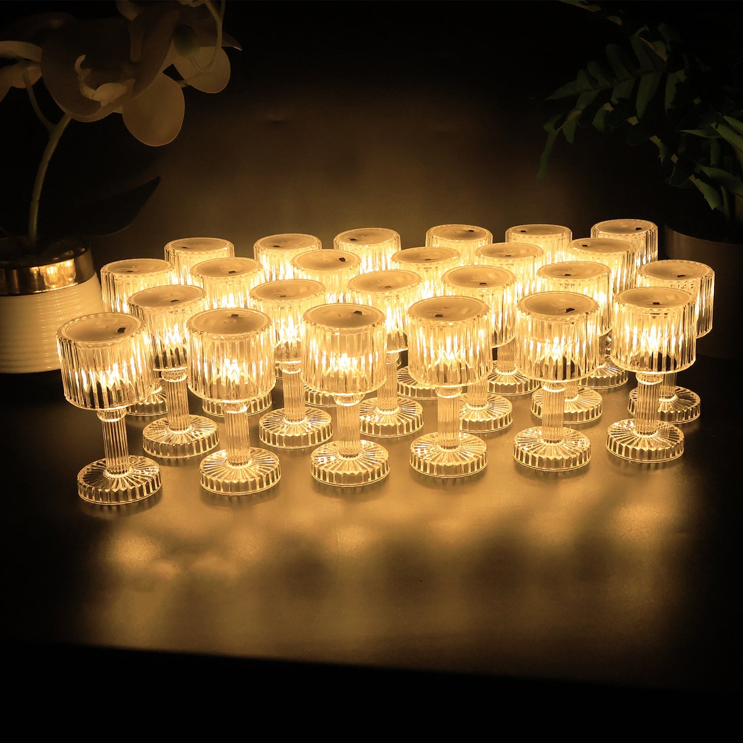 Ribbed crystal-style LED mini lamps with pedestal stands emitting warm light for indoor décor