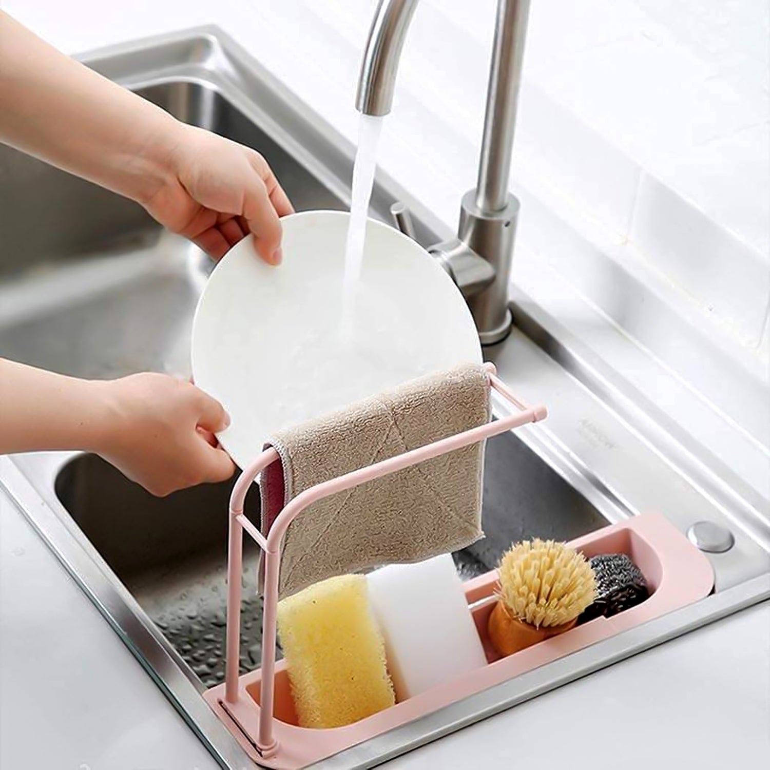 Expandable sink rack organising soap, sponges, and brushes on kitchen sink