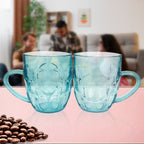 Stacked clear plastic shake mugs showing textured grip and handles