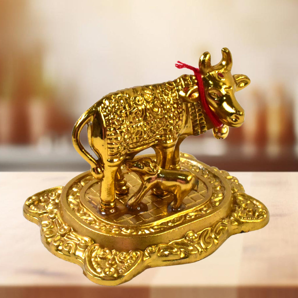 Front view of golden metal Kamdhenu Cow with calf showpiece