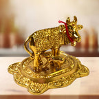 Front view of golden metal Kamdhenu Cow with calf showpiece