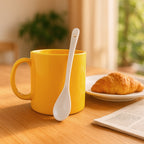 Close-up of plastic cup with ergonomic handle and matching spoon