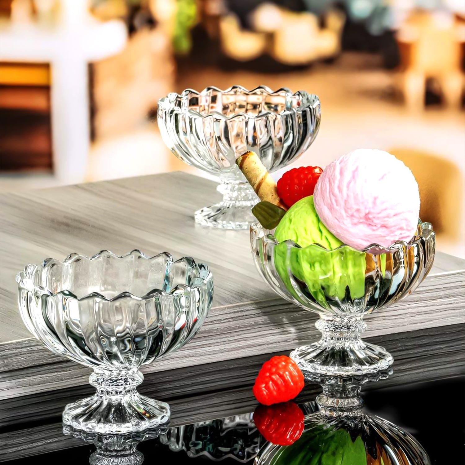 Sparkling clear glass parfait cups showcasing beautifully layered fruits and cream.