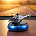 Solar helicopter car air freshener rotating on car dashboard in sunlight