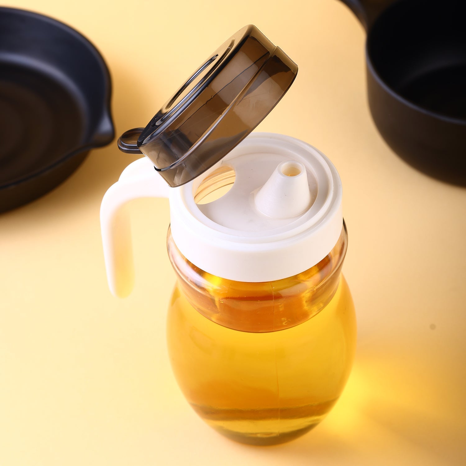 Durable plastic oil bottle with an easy-pour spout.