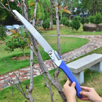 Folding gardening saw efficiently cutting a thick branch.