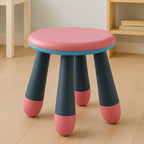 A young child seated comfortably on the Bub Barrier foldable baby stool.
