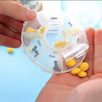 Close-up of pill box compartments with bold and Braille day labels for weekly medicine