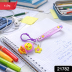 Close-up of cartoon duck keychain showing colorful rainbow silicone strap and duck charm