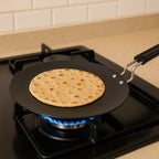Black non-stick flat tawa ideal for chapati and dosa making