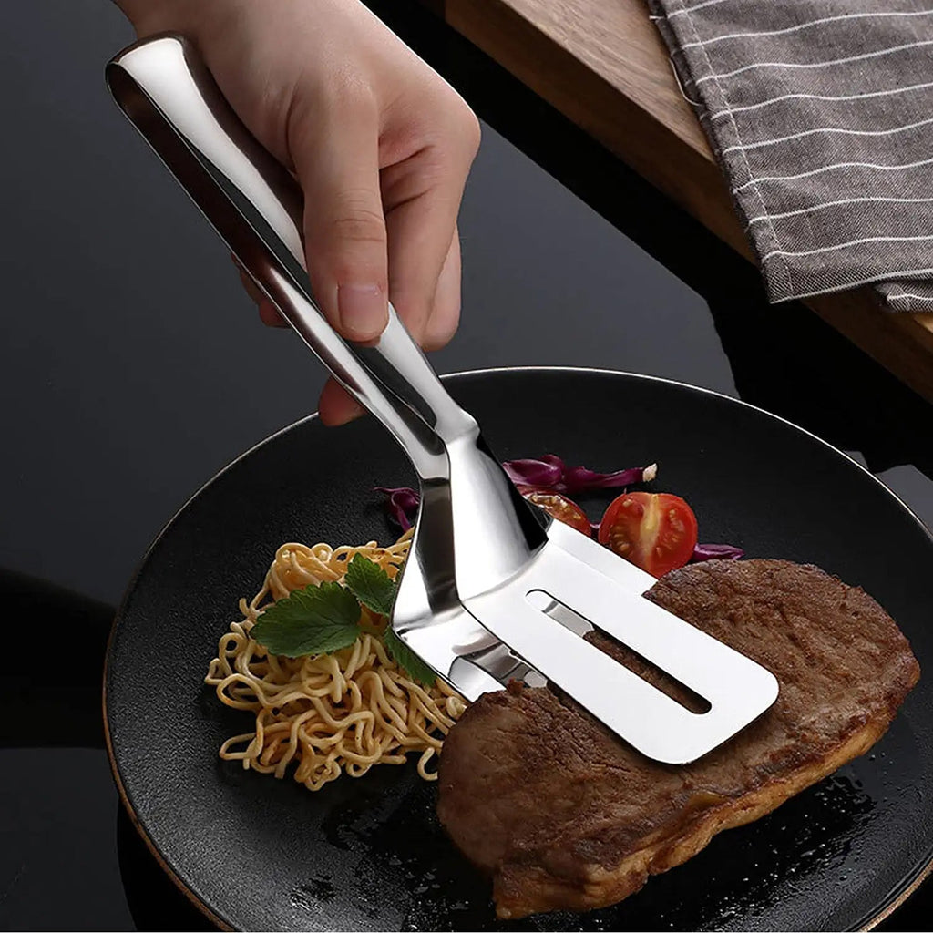 Ergonomic stainless steel kitchen tong holding grilled vegetables.