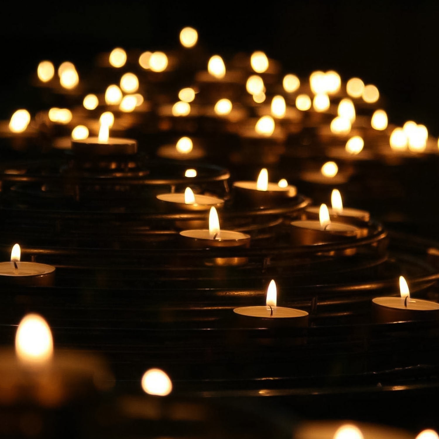 Group of smokeless tealight candles in a clear display box, ready for use.