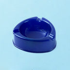 Side view of dark blue plastic ashtray with smokeless deep bowl