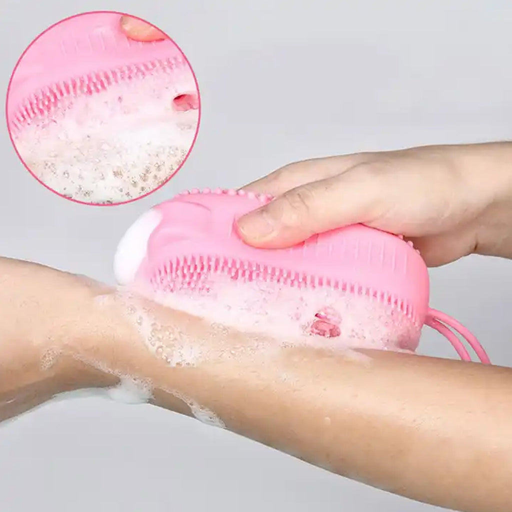 Double-sided silicone bath brush shown in use for a thorough skin cleanse.