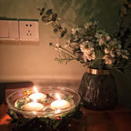 Stylish glass floating candle holder enhancing table decoration.