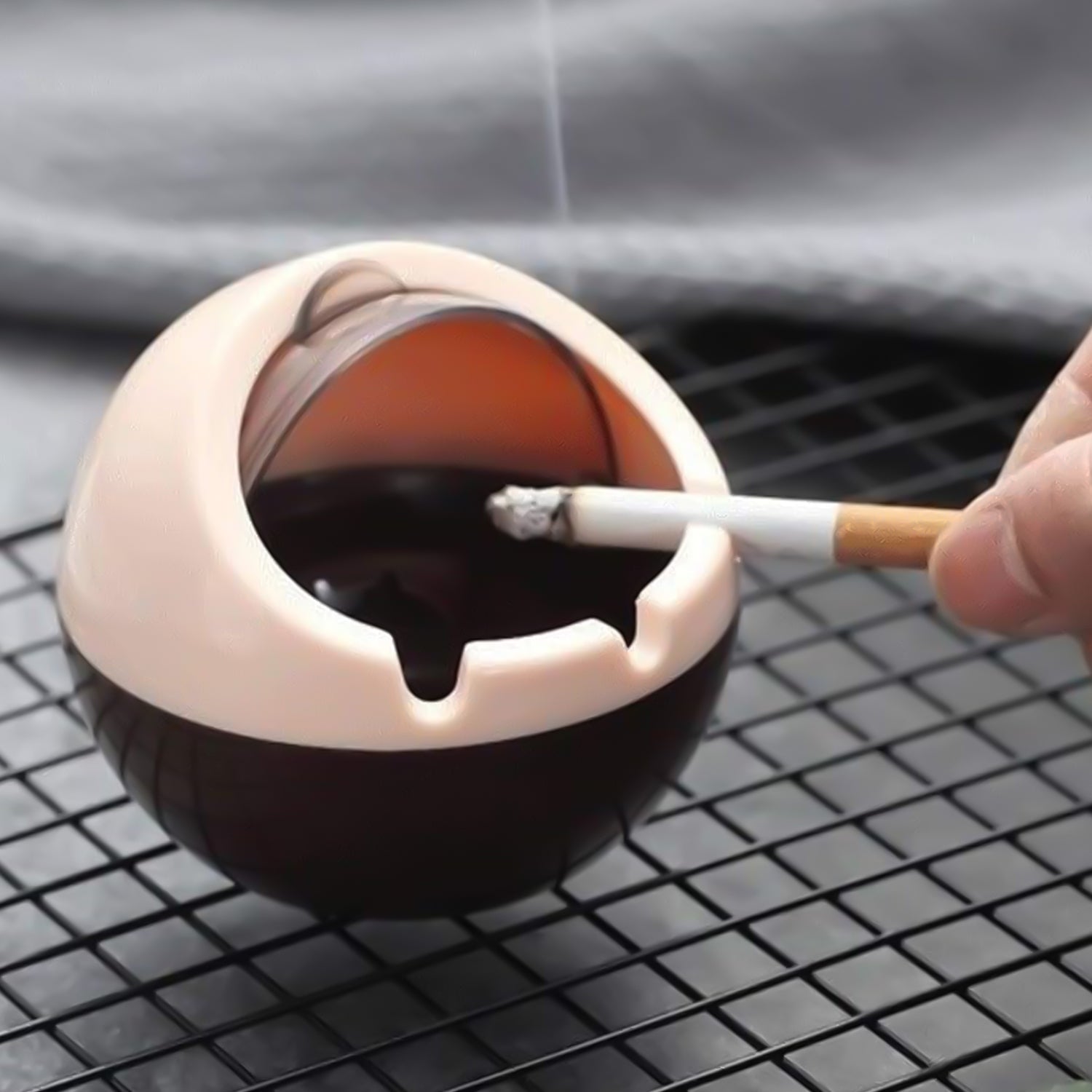 Windproof ashtray with hinged lid preventing ash escape outdoors