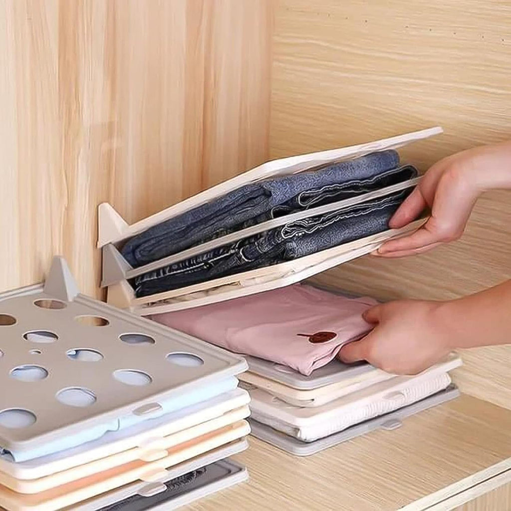 Wardrobe drawer with multiple Clothes Folding Boards neatly stacked, showcasing organized garments.