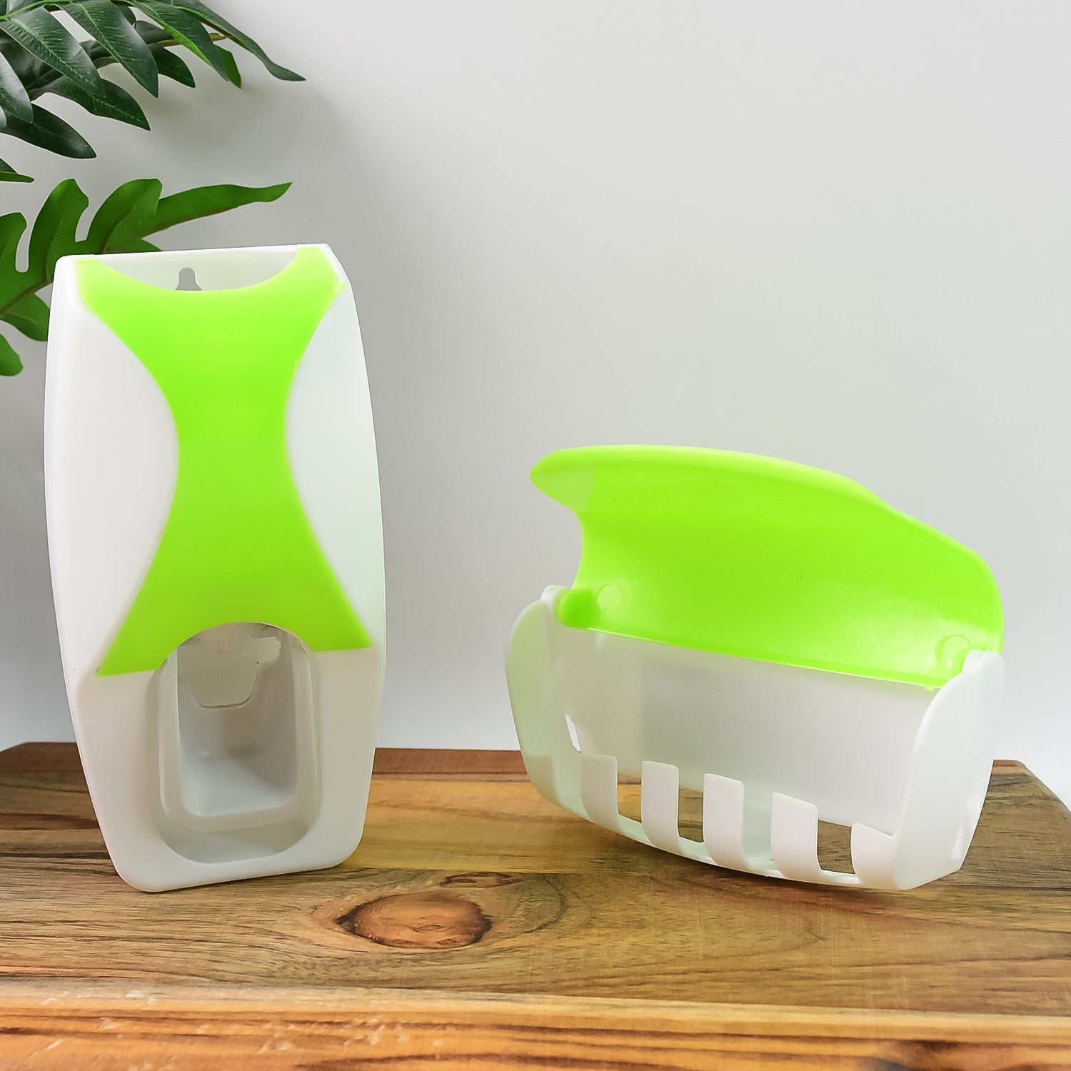 Compact automatic toothpaste dispenser and toothbrush holder set for a tidy bathroom.