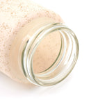 Detailed shot of the natural bamboo lid and borosilicate glass bottle.
