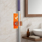 Wall clip holder for mops and brooms
