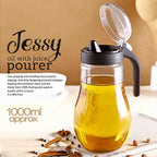 Ergonomic oil and juice dispenser bottle with anti-drip spout