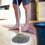 Replaceable microfiber mop head attached to stainless steel handle mop