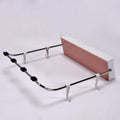 White foldable wash basin rack mounted on a wall, ready for use.