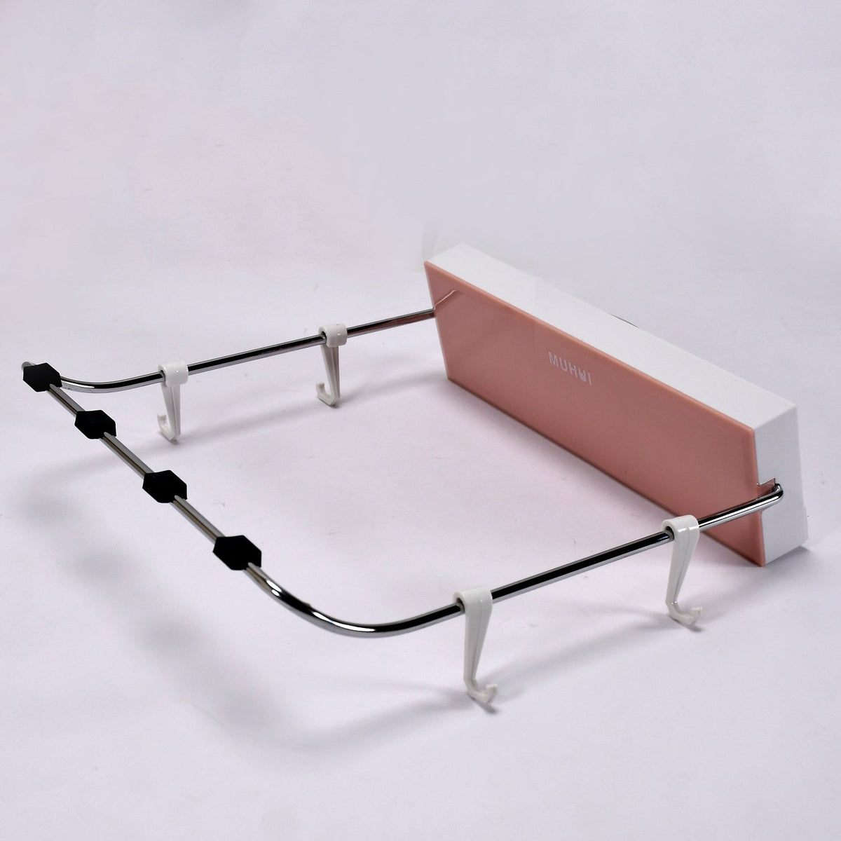 White foldable wash basin rack mounted on a wall, ready for use.