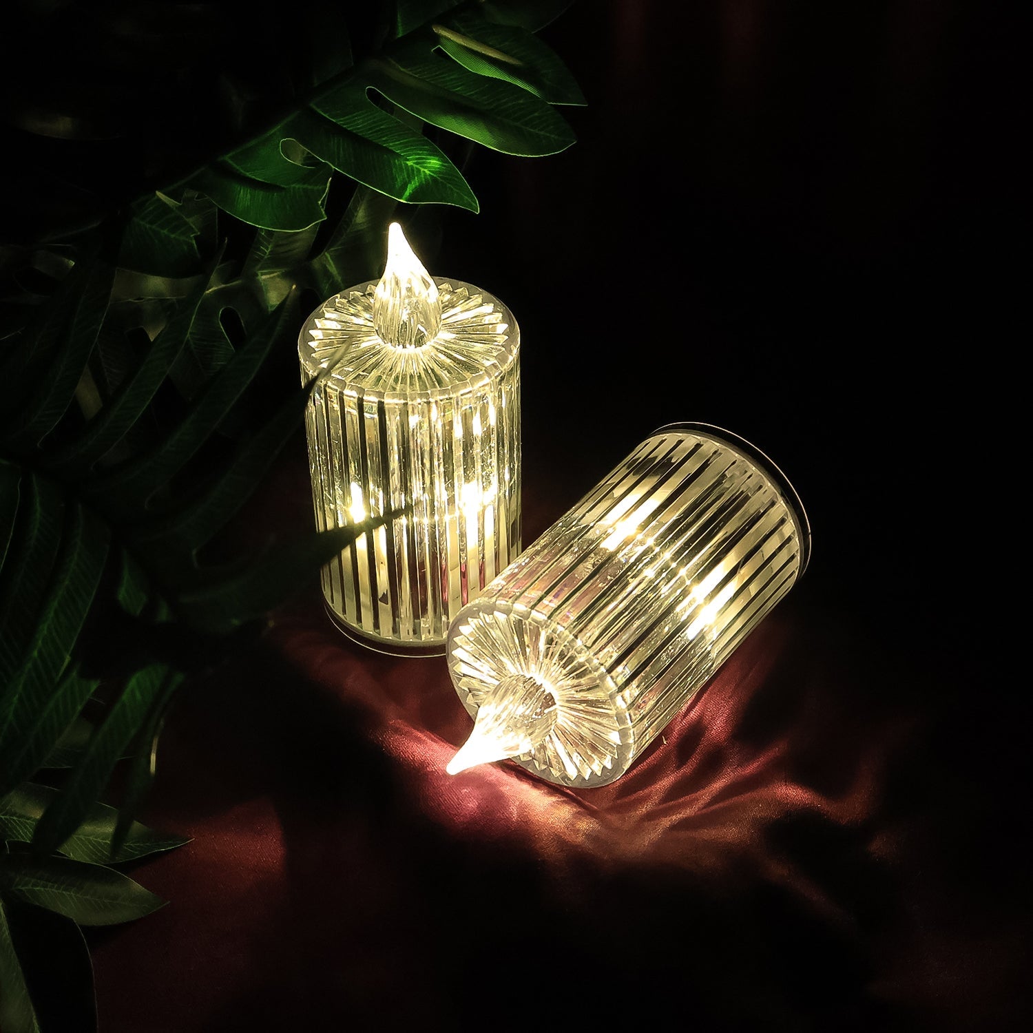 Warm yellow flickering LED flame on crystal-effect candle light