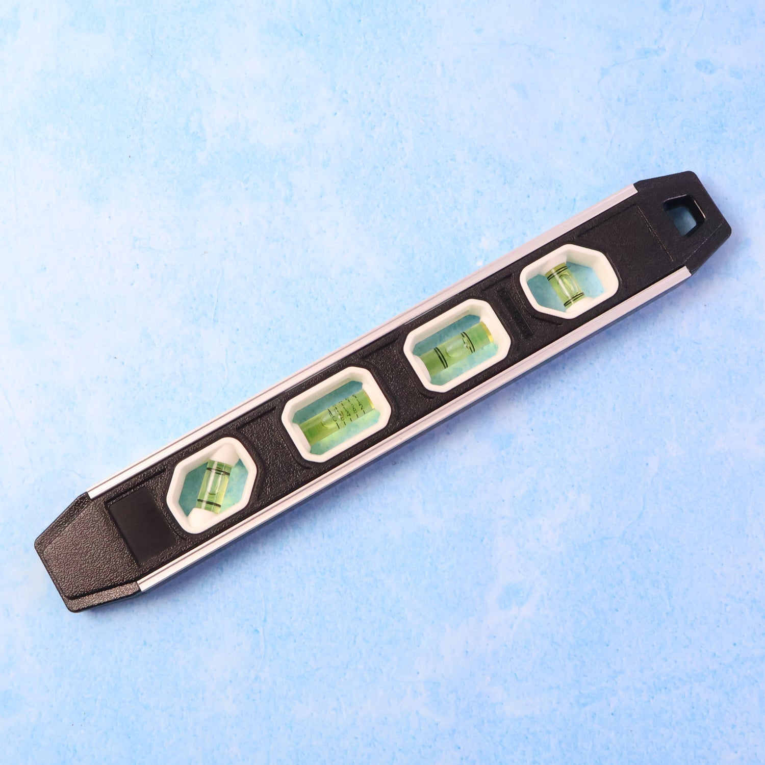 Aluminum spirit level measuring tool showing 3 bubble vials for precise leveling