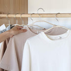Multiple BathNova space-saving hangers neatly organized in a closet.
