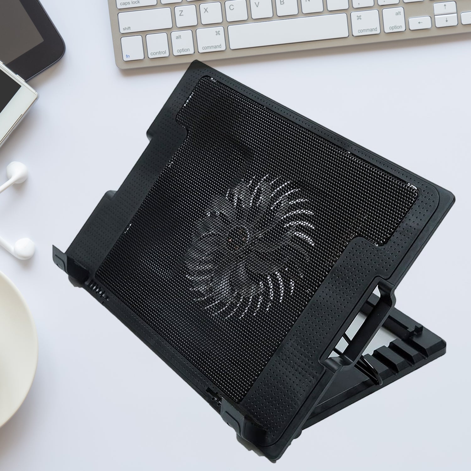 Sleek black laptop cooling pad with fan and adjustable stand, ready for use.