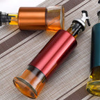 Glass oil dispenser with spill-proof golden pour spout and plastic cover