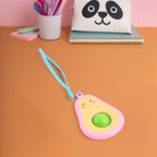 Avocado mini push pop keychain shown hanging from strap