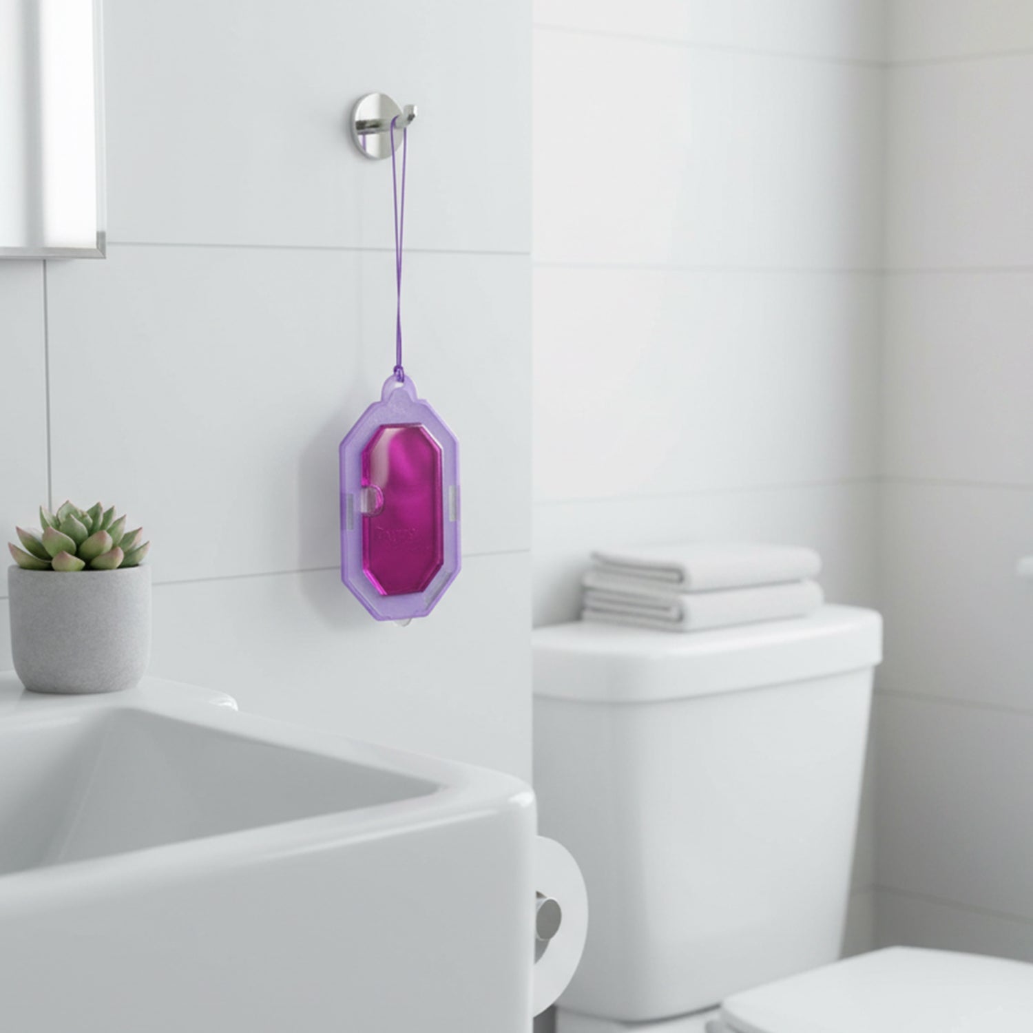 Compact lavender scent toilet freshener hanging in bathroom