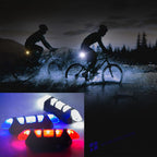 Close-up of a blue rechargeable bicycle front light mounted on handlebars, showing its sleek design.