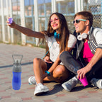 Person holding a mixed-color BPA-Free water bottle for on-the-go hydration.