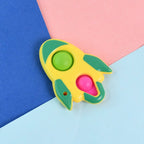 Close-up of silicone bubbles being popped on rocket fidget keychain toy