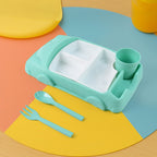 Happy child enjoying a meal from the colorful car-themed compartment plate.