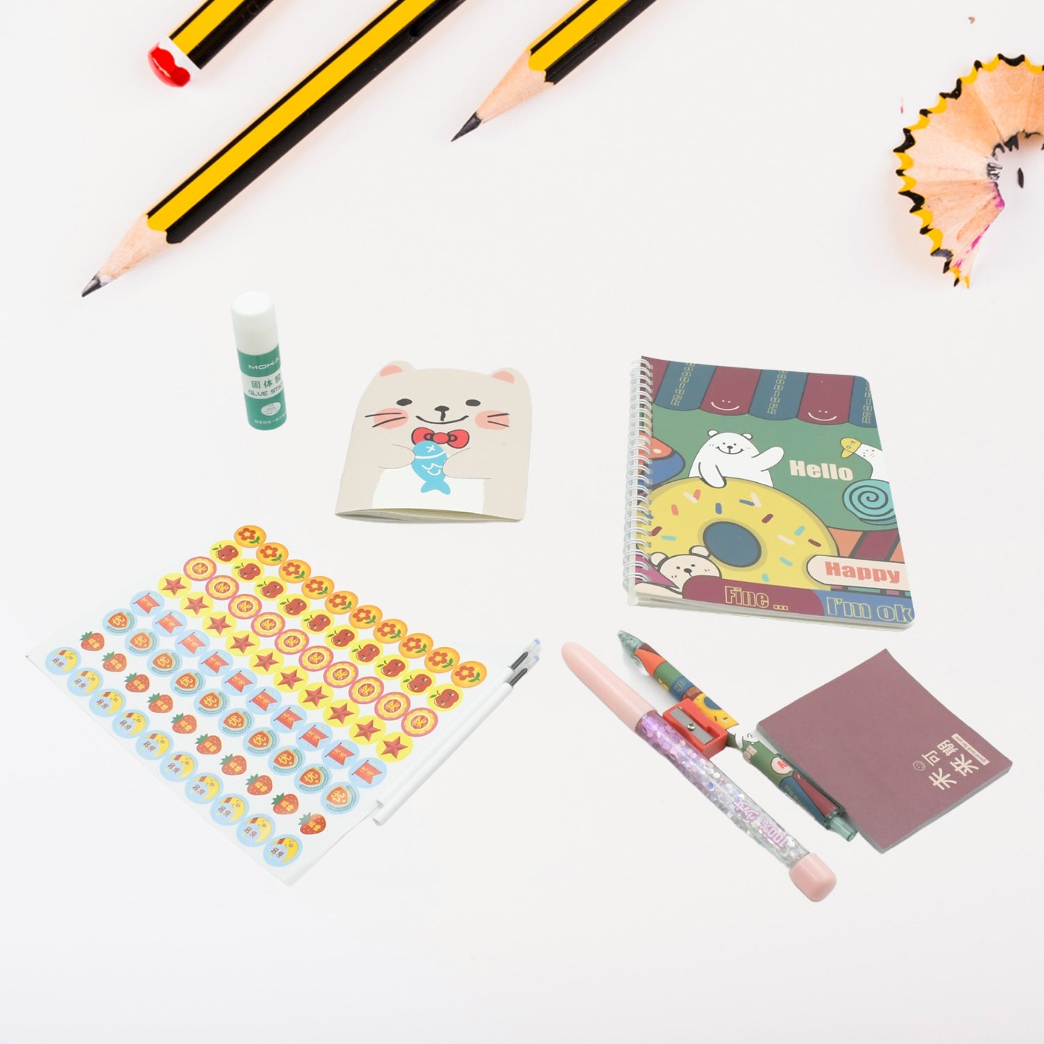 Vibrant cartoon stationery box with a notebook, pen, and eraser for school kids.