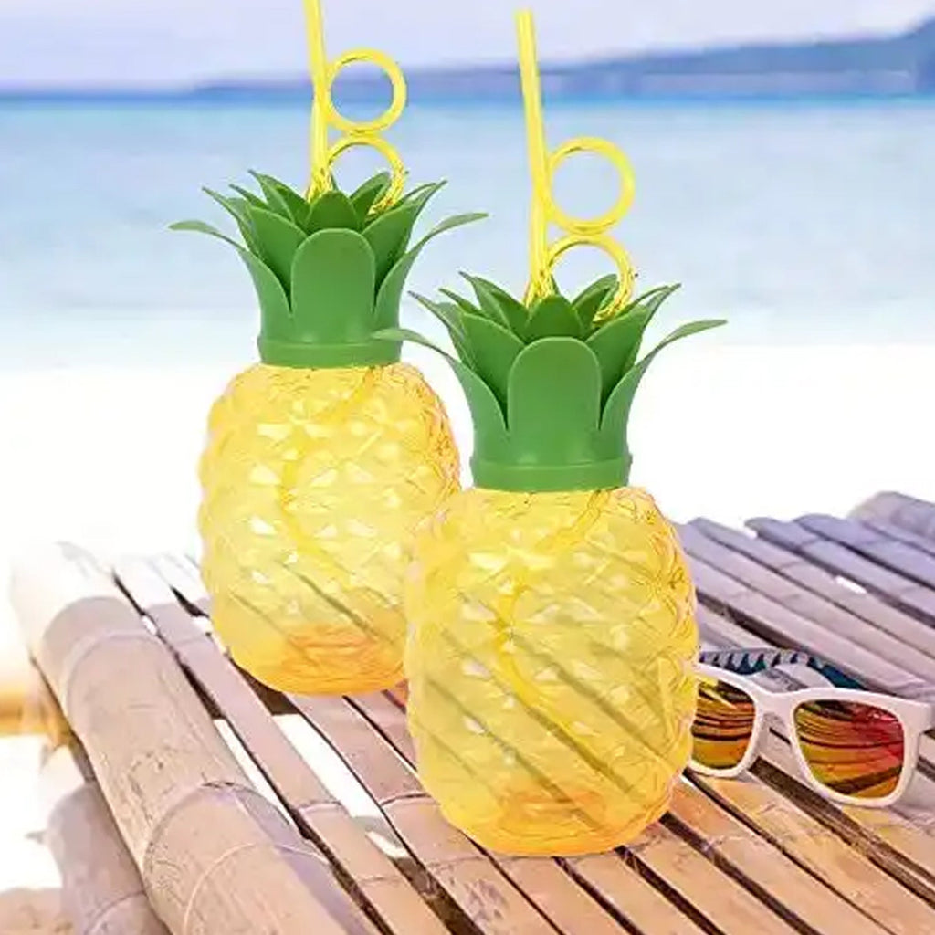Top-down view of the pineapple cup with its green leaf lid and reusable straw.