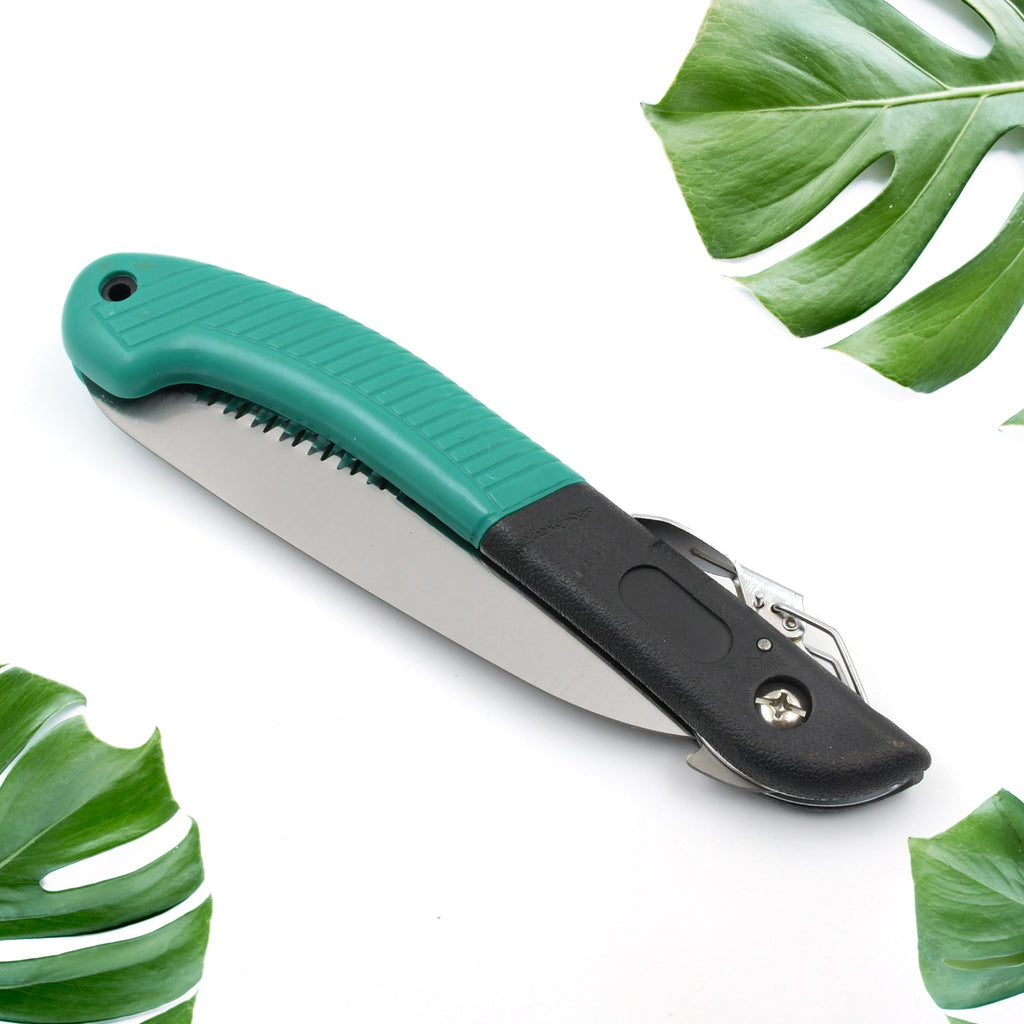 Close-up of the folding handsaw's safety lock mechanism for secure storage.