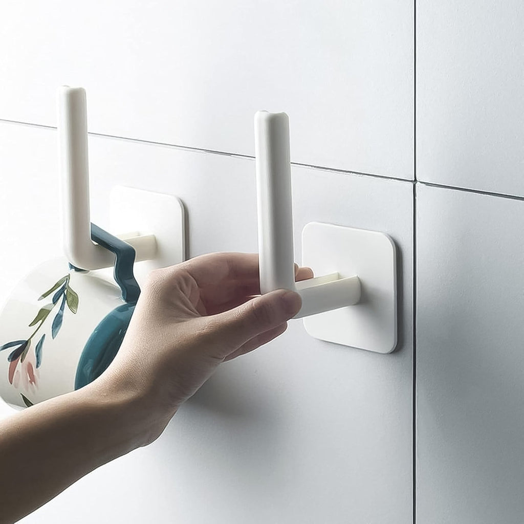 A set of two white hanging storage racks with adhesive hooks displayed in a modern kitchen, organizing spices and utensils.