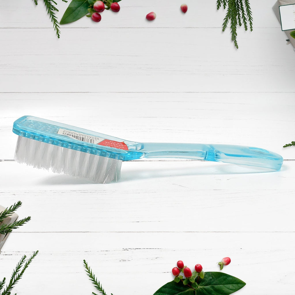 Ergonomic scrubbing brush being used to clean the sole of a shoe.